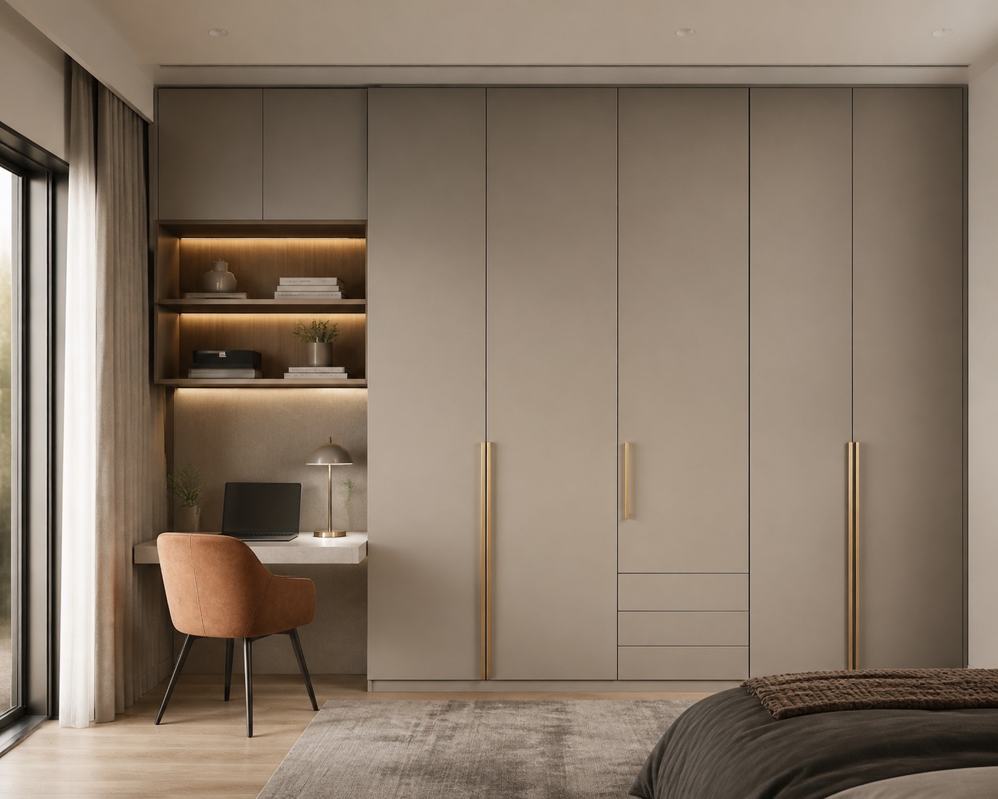 Taupe wardrobe wall with brass handles, shelving and a compact desk